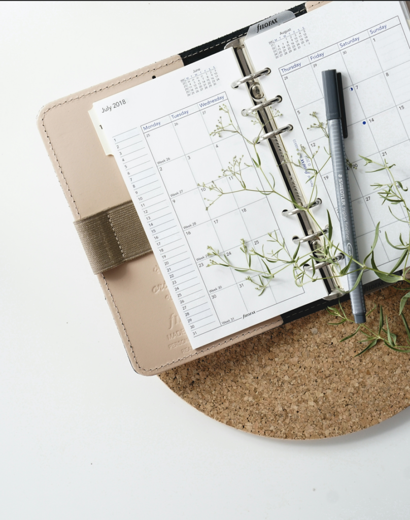 grey and black pen on a calendar book