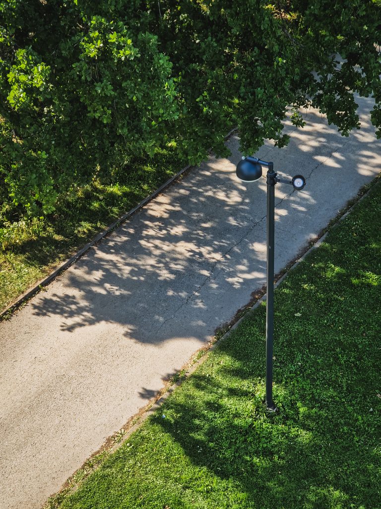 A scenic summer pathway with lush green trees and grass in Haapsalu, Estonia.